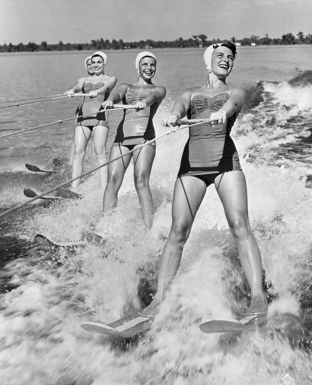 Four Young Woman Waterskiing in the Sea